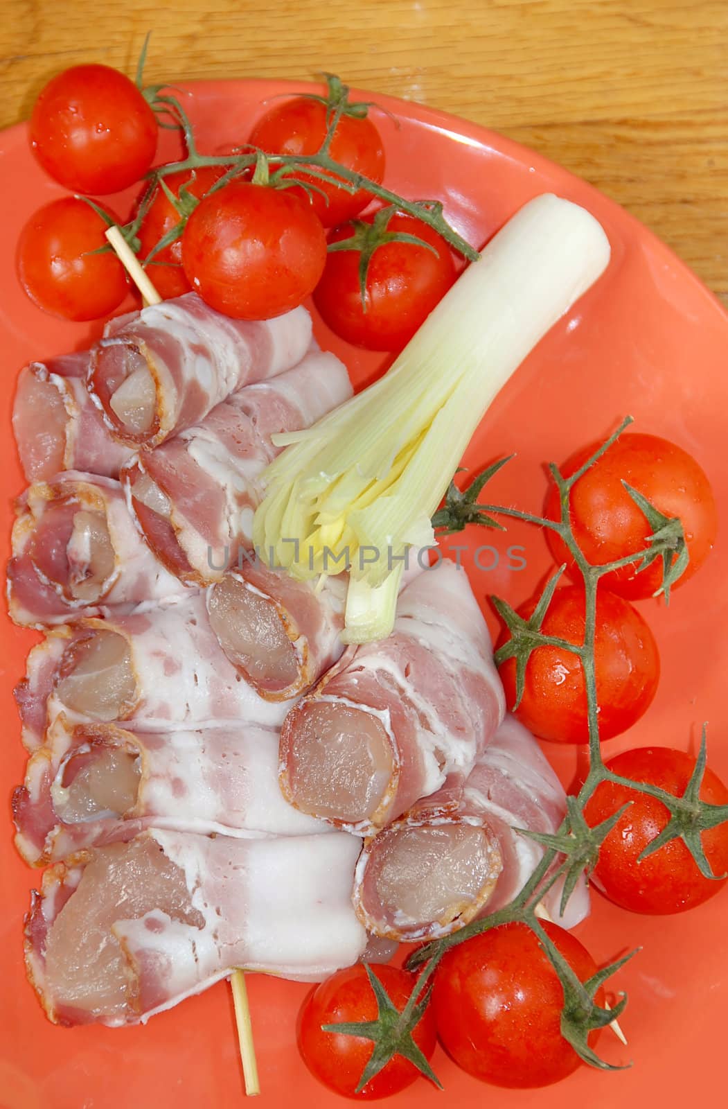 appetizing red cherry tomatoes closeup on red plate