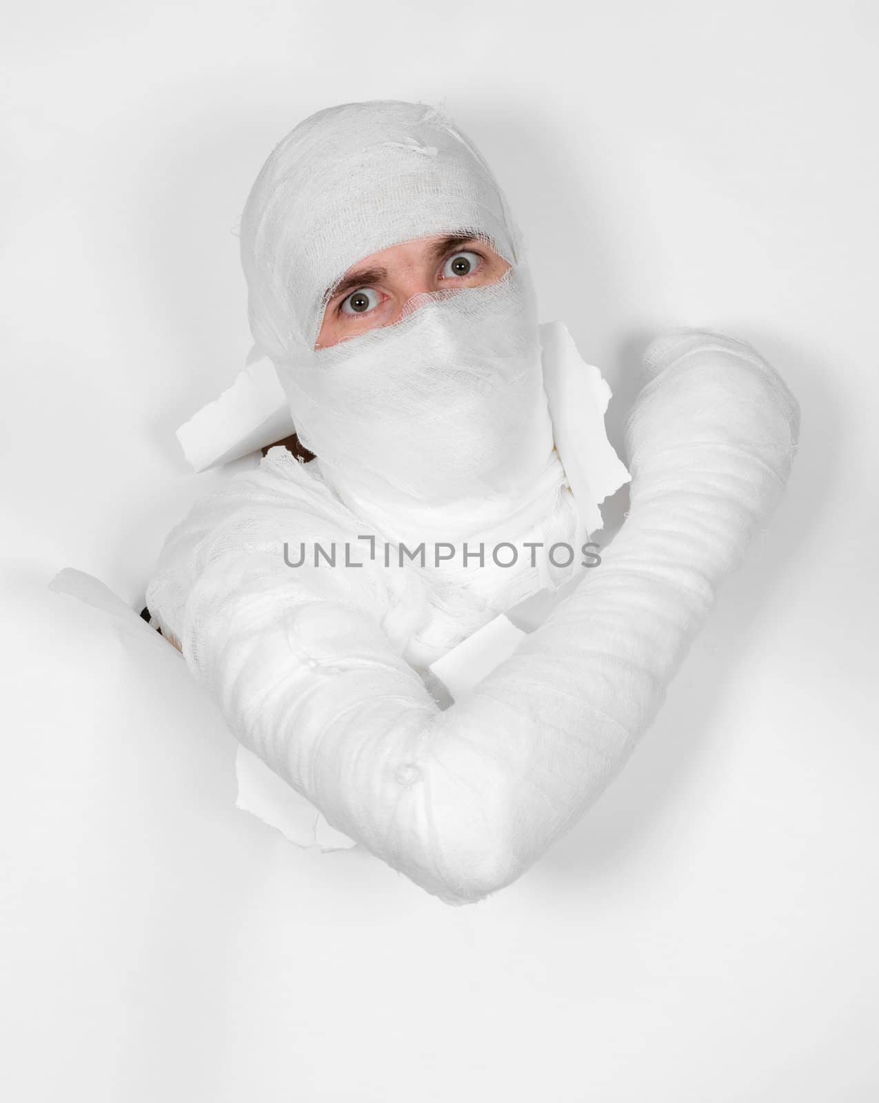 Boy in bandage put out from hole in white paper