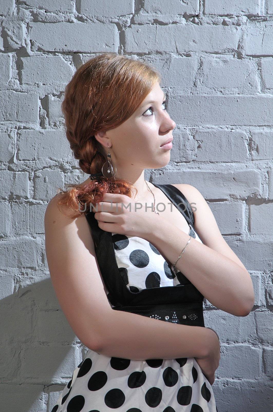 young woman on  brick wall background