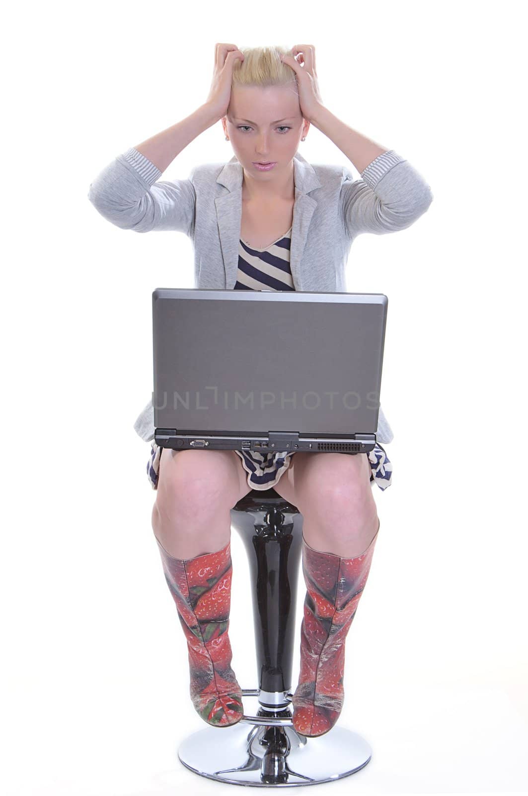 Beauty woman sits with a laptop on knees and sticks to two hands for a head