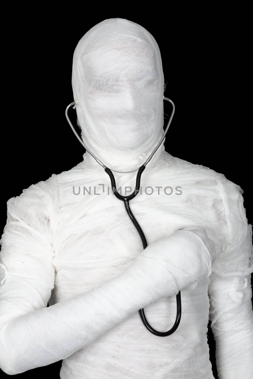 Man in costume mummy with stethoscope by pzaxe