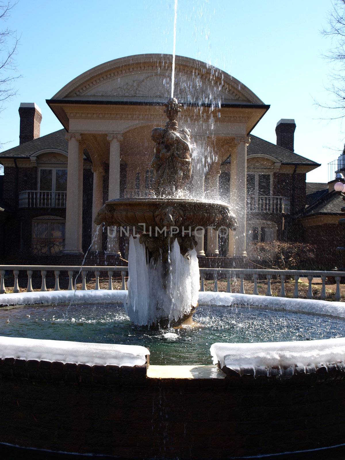 A water fountain with ice during the winter