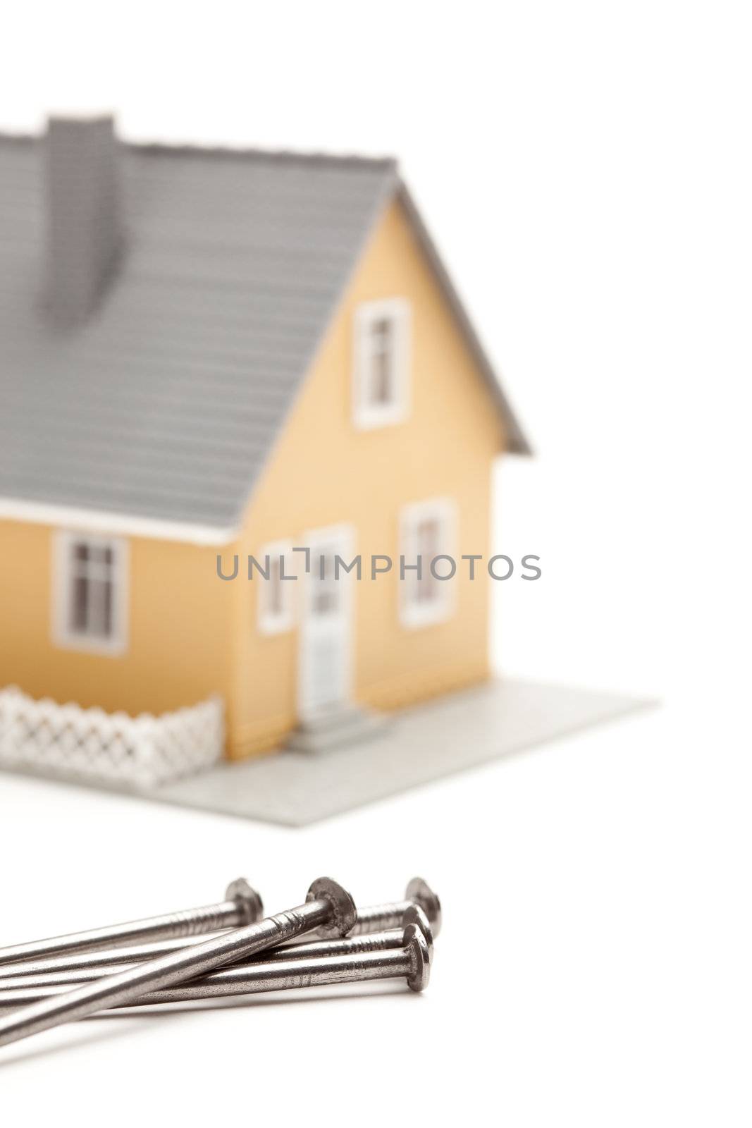 House and Nails Isolated on a White Background.