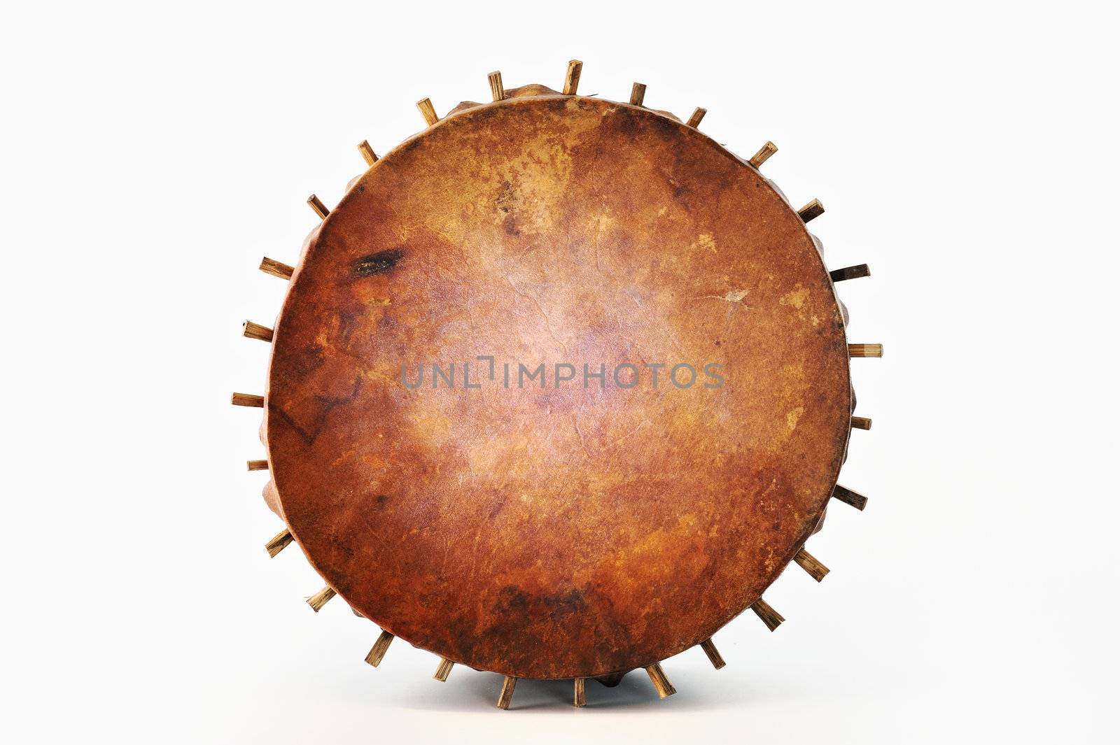 Ancient tambourine from a skin and wood on a white background