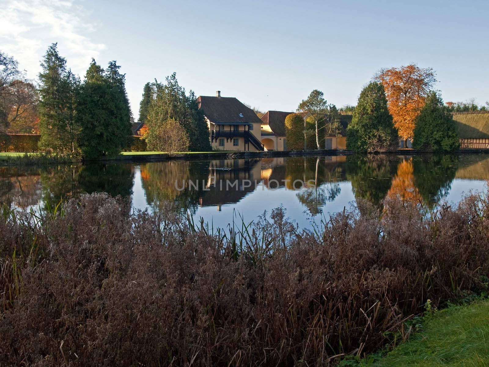 Beautiful traditional country houses reflected in a lake Denmark