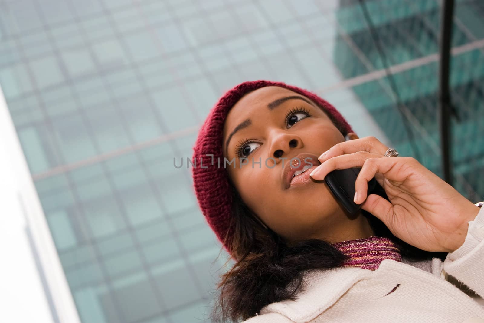 An attractive business woman talking on her cell phone in the city.