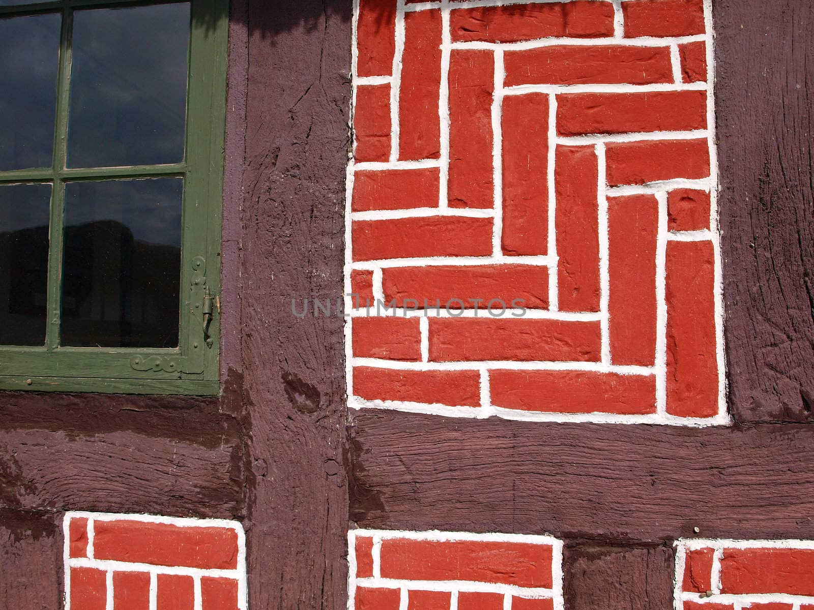 Traditional German country home made with bricks and wood in bright red colors