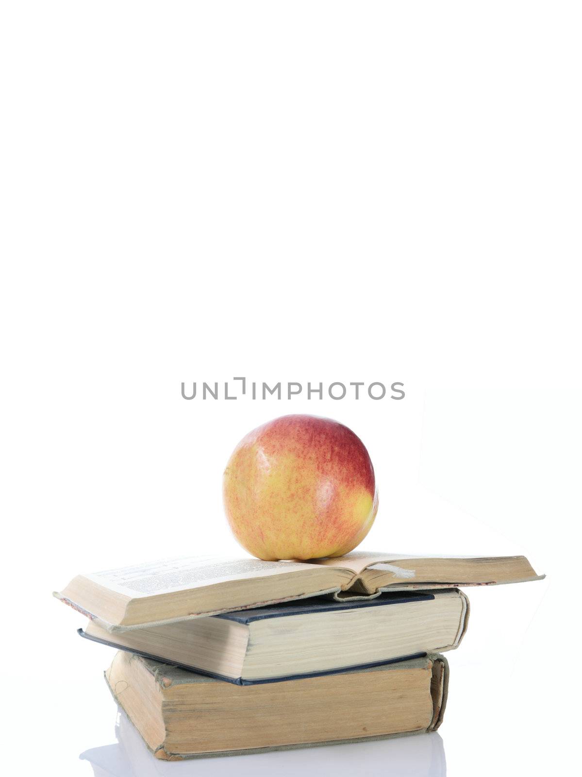 Red apple on books isolated on white