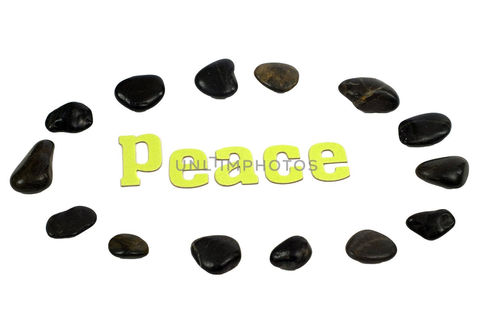 Peace concept with the word peace, surrounded by relaxing river rocks, isolated against a white background