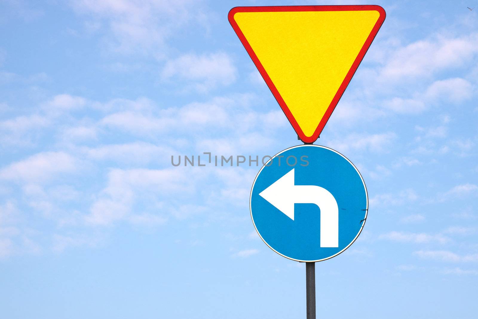 Triangle traffic sign with blue sky and clouds background