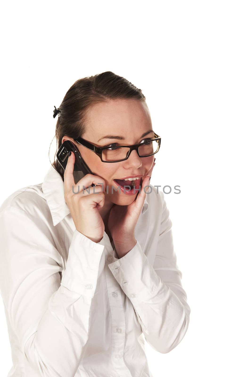 Beautiful girl getting good news on the phone, seen against white background