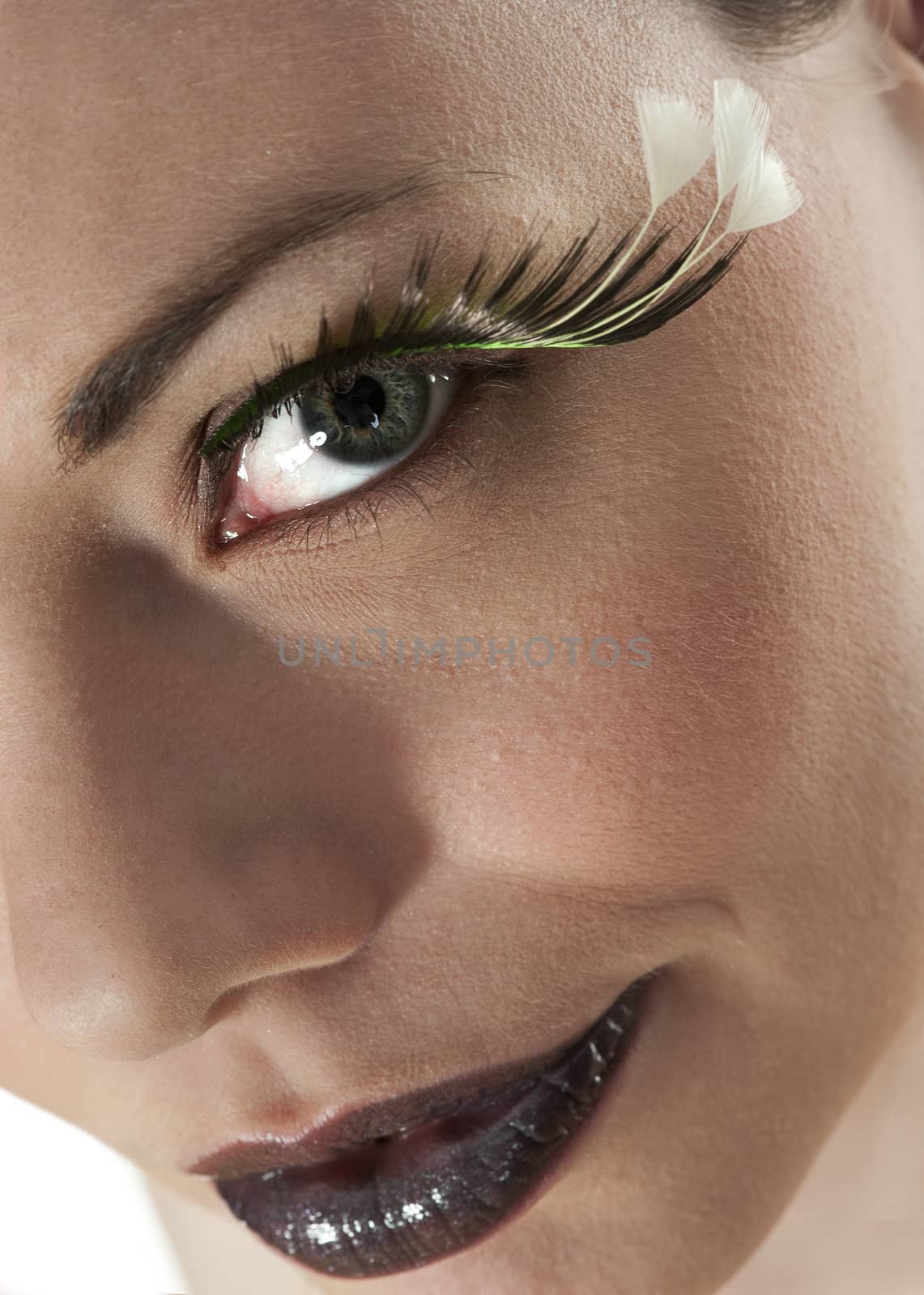 Beautiful girl seen closeup, wearing ekstraordinary makeup