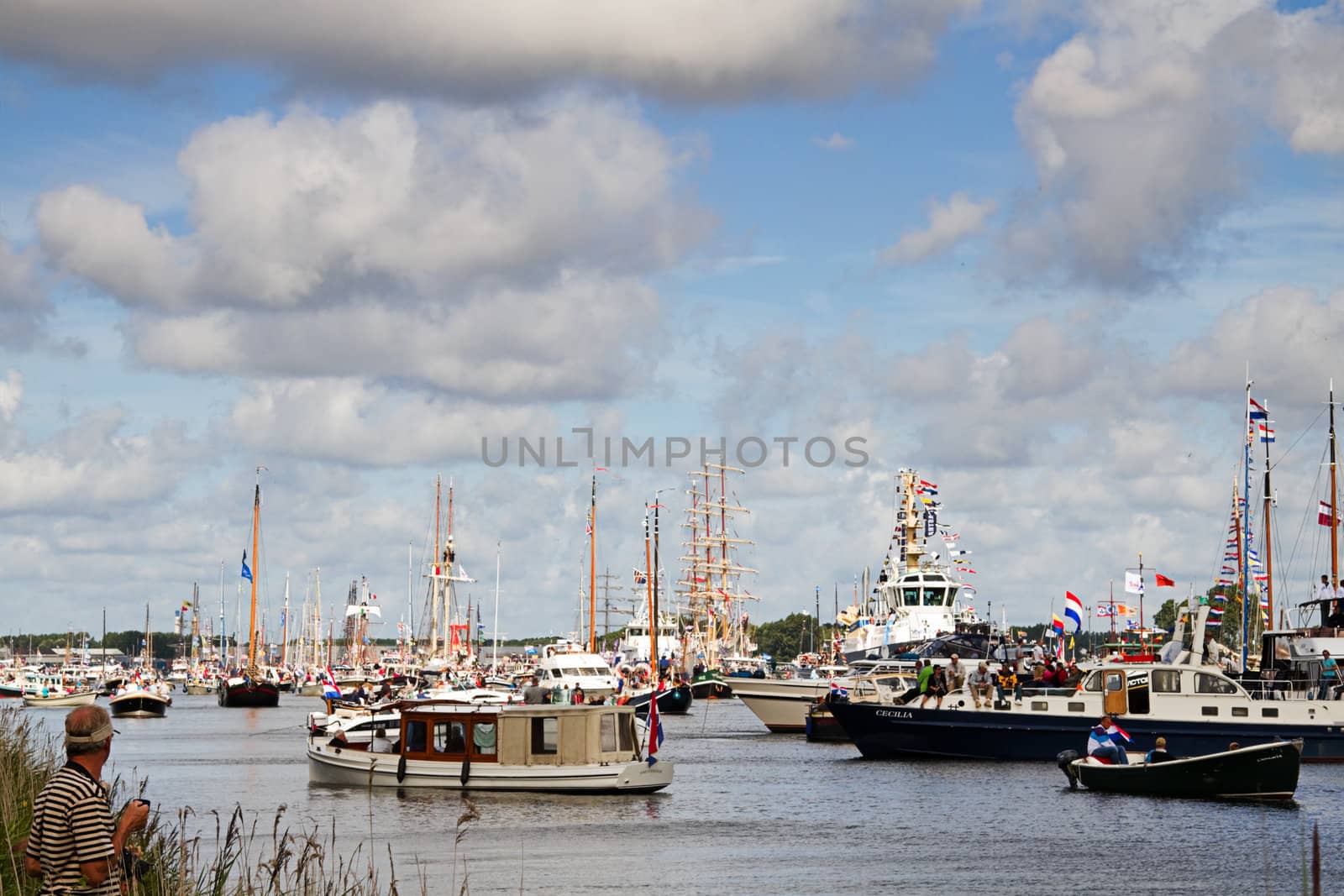 SAIL AMSTERDAM 2010 -IJMUIDEN, THE NETHERLANDS - AUGUST 2010: Sail 2010 starts with the spectaculair Sail-in Parade.  50 Tall ships and more than 500 of  naval ships, replicas and yachts sail in convoy through the North Sea Canal from IJmuiden to Amsterdam. Thousands of private boats accompany the fleet and more than 300.000 visitors watch the parade from the banks. August 19, 2010, IJmuiden, the Netherlands