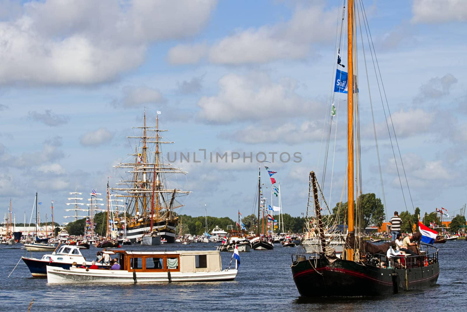 SAIL AMSTERDAM 2010 -IJMUIDEN, THE NETHERLANDS - AUGUST 2010: Sail 2010 starts with the spectaculair Sail-in Parade.  50 Tall ships and more than 500 of  naval ships, replicas and yachts sail in convoy through the North Sea Canal from IJmuiden to Amsterdam. Thousands of private boats accompany the fleet and more than 300.000 visitors watch the parade from the banks. August 19, 2010, IJmuiden, the Netherlands