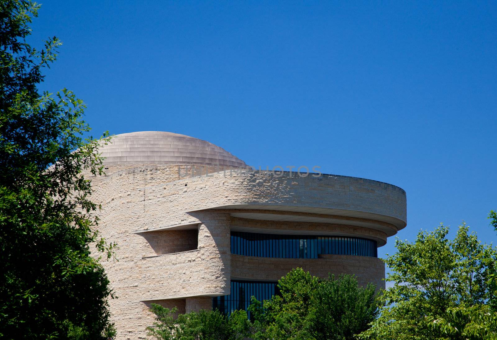 The Museum of the American Indians in Washington DC taken from the tree-filled space of the Botanical Gardens