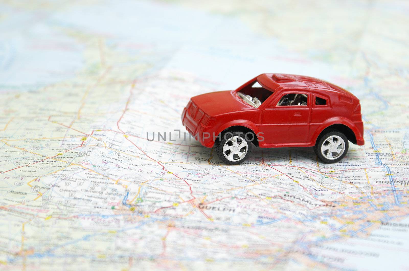 A toy car is driving on a map.