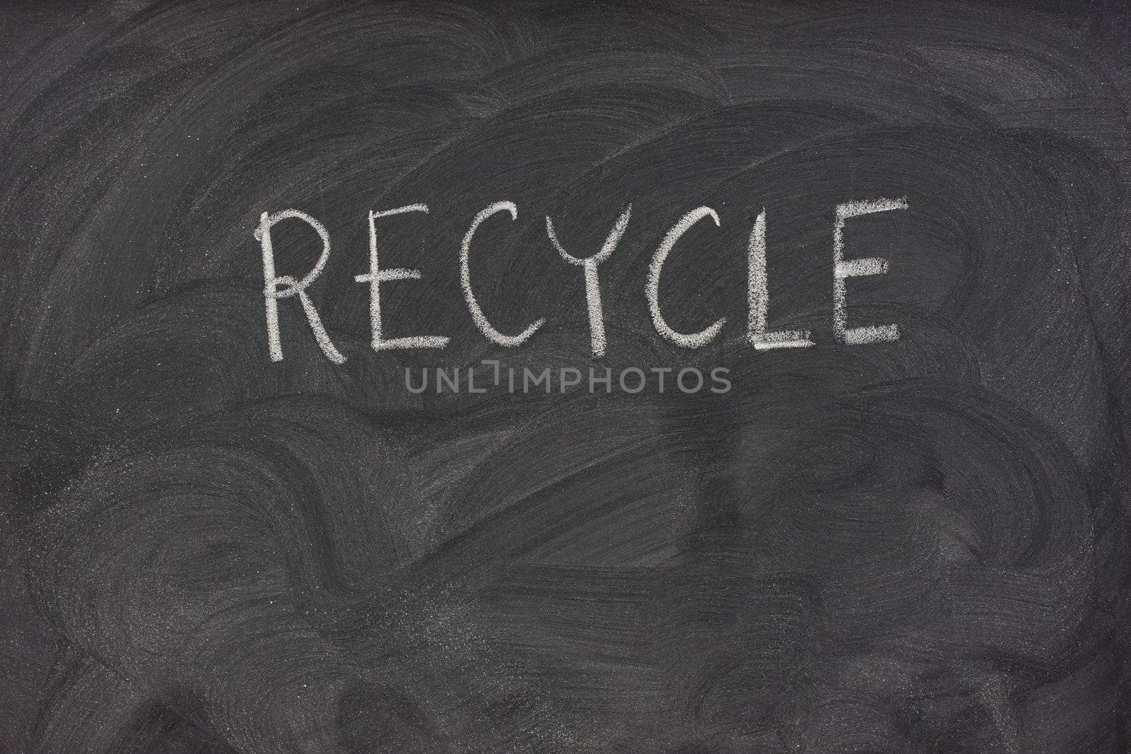 recycle handwritten with white chalk on a school blackboard with eraser smudges