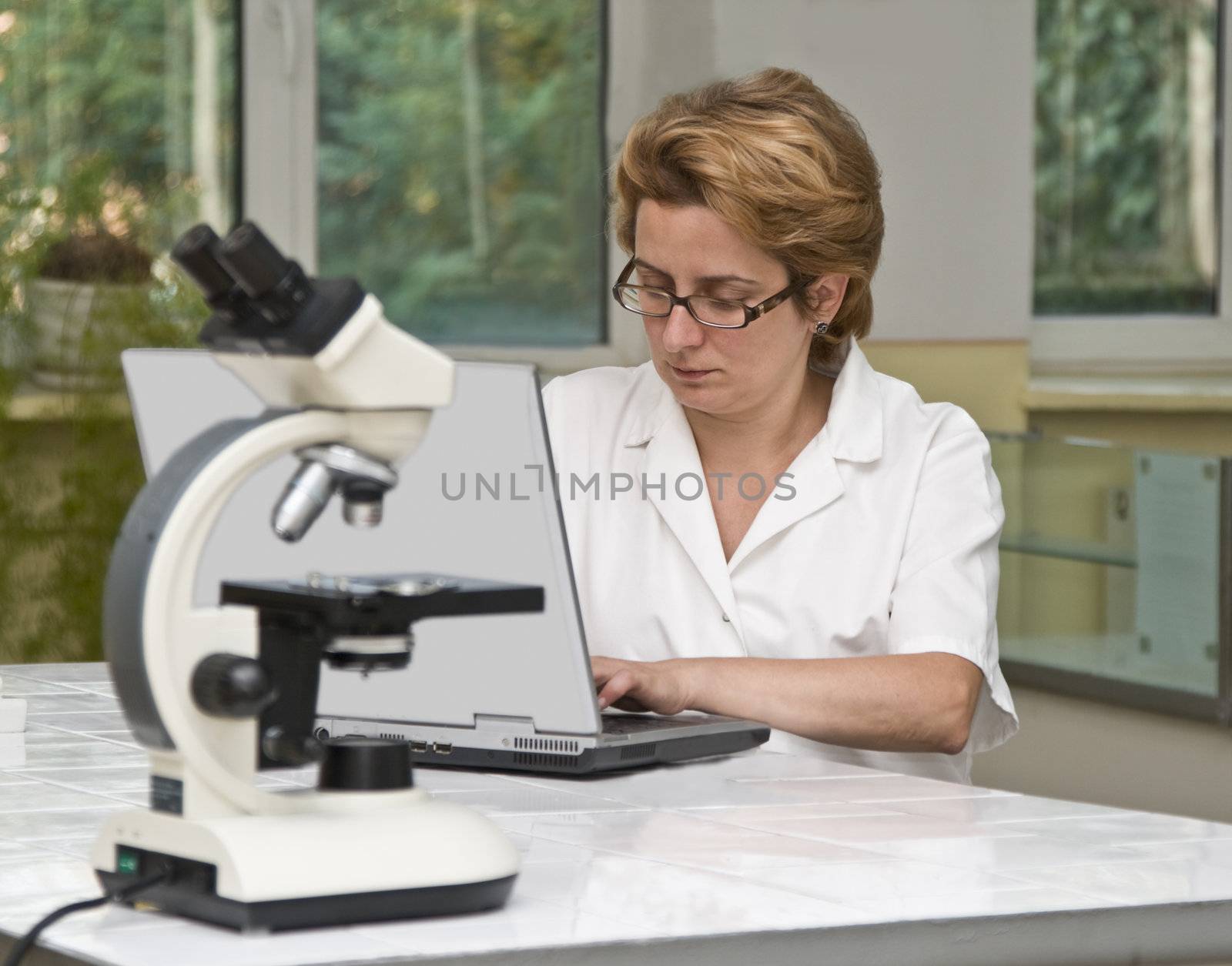 Female researcher working on a laptop in the laboratory.