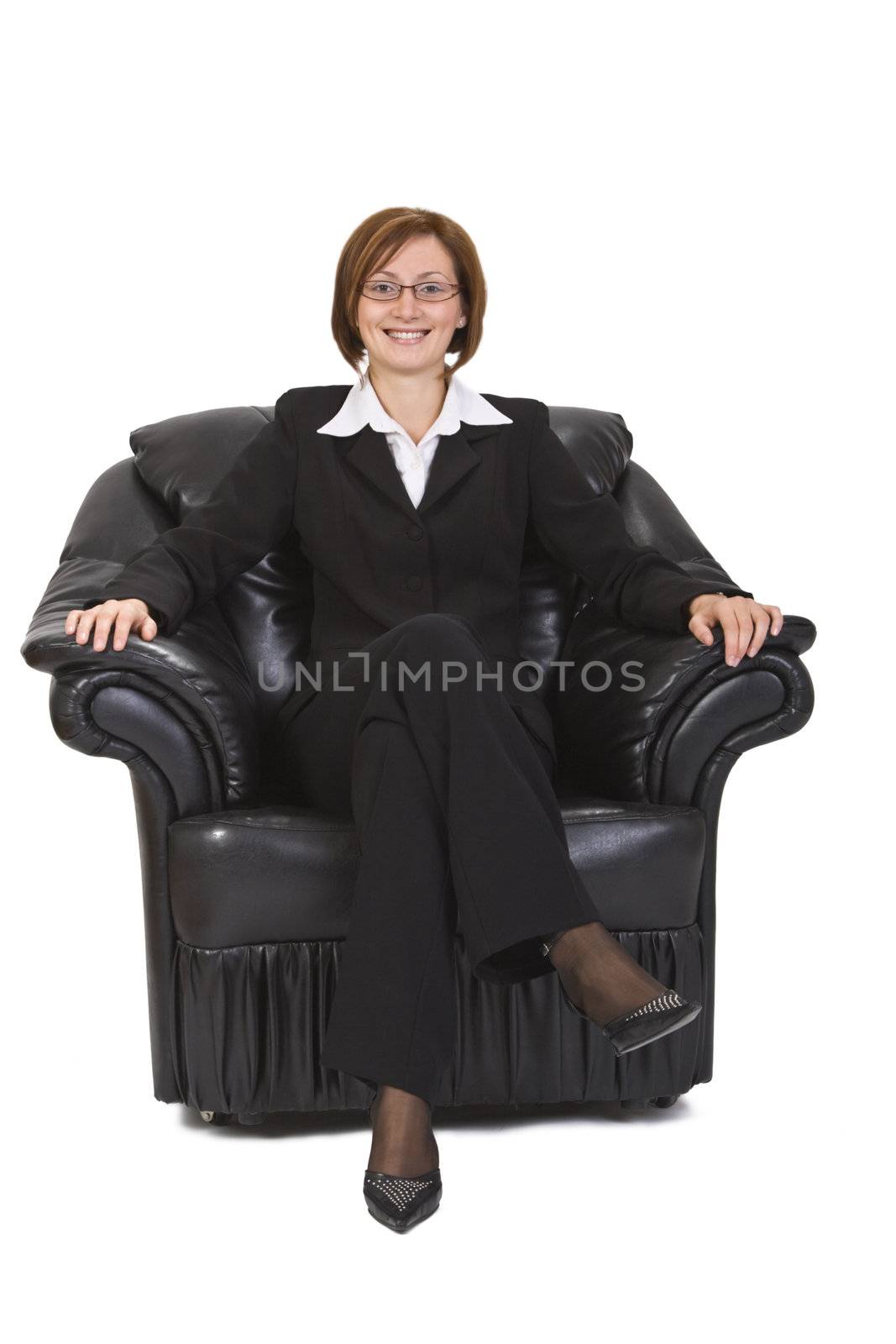 Businesswoman sitting in an armchair against a white background.