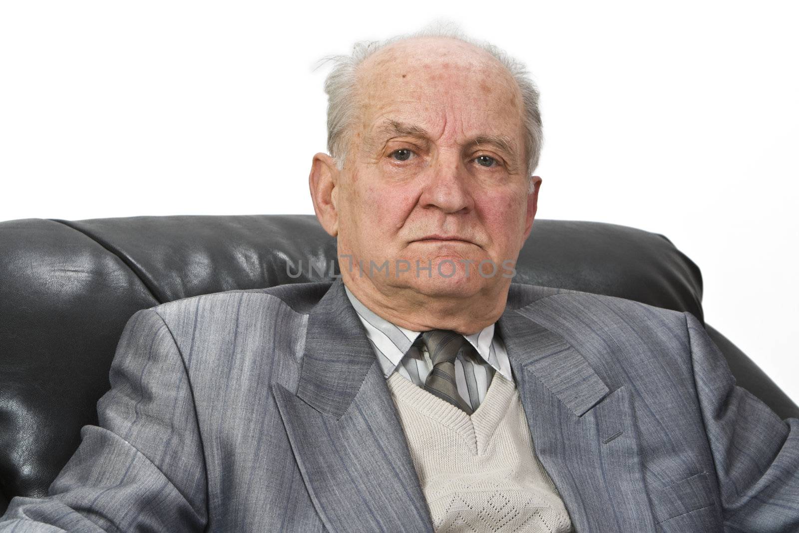 Portrait of a senior man sitting in an armchair isolated against a white background.