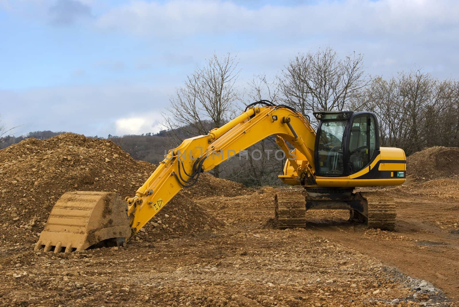 It's a side view of a yellow mechanical shovel