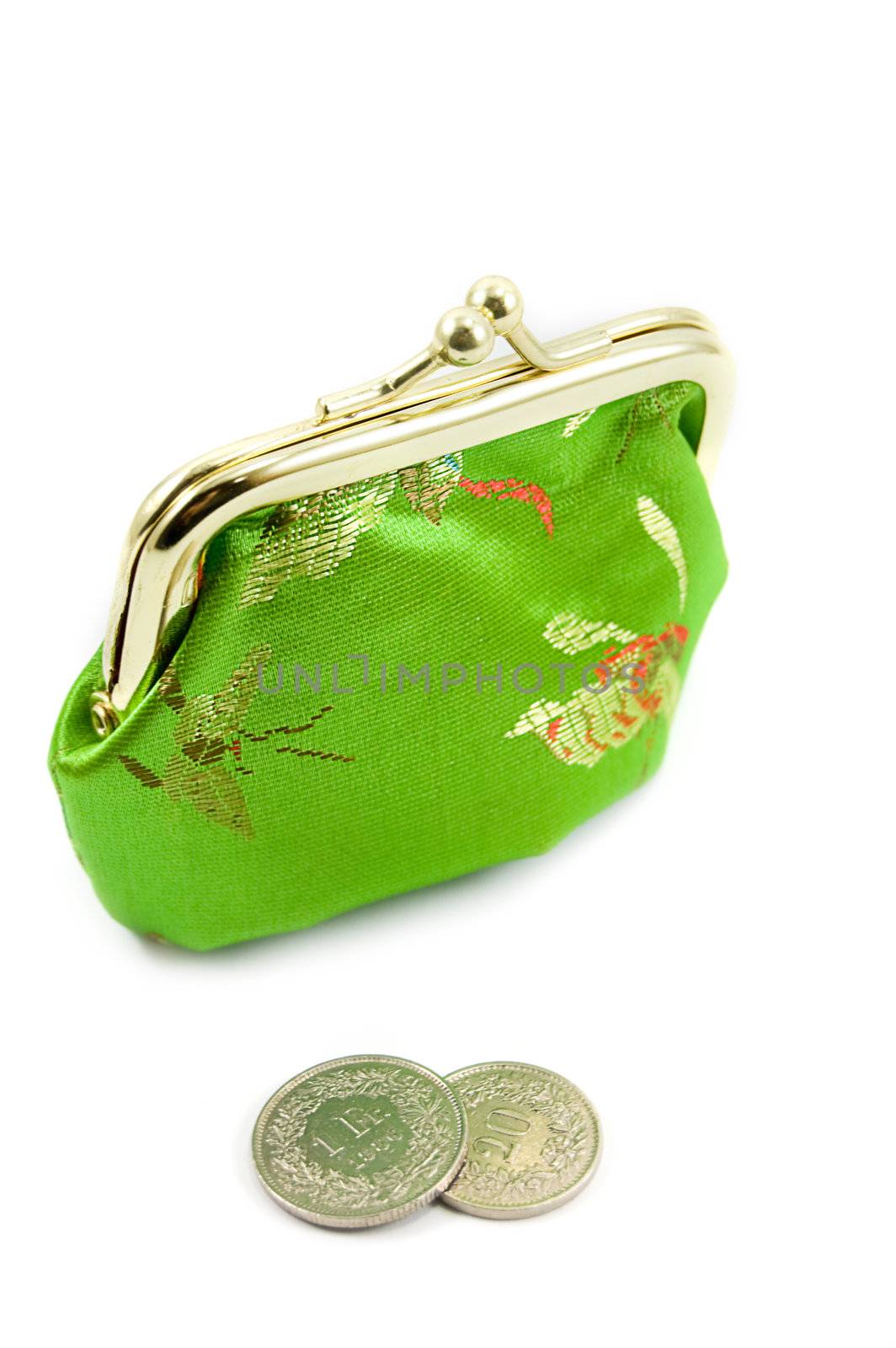 Green purse with some coins in front of it