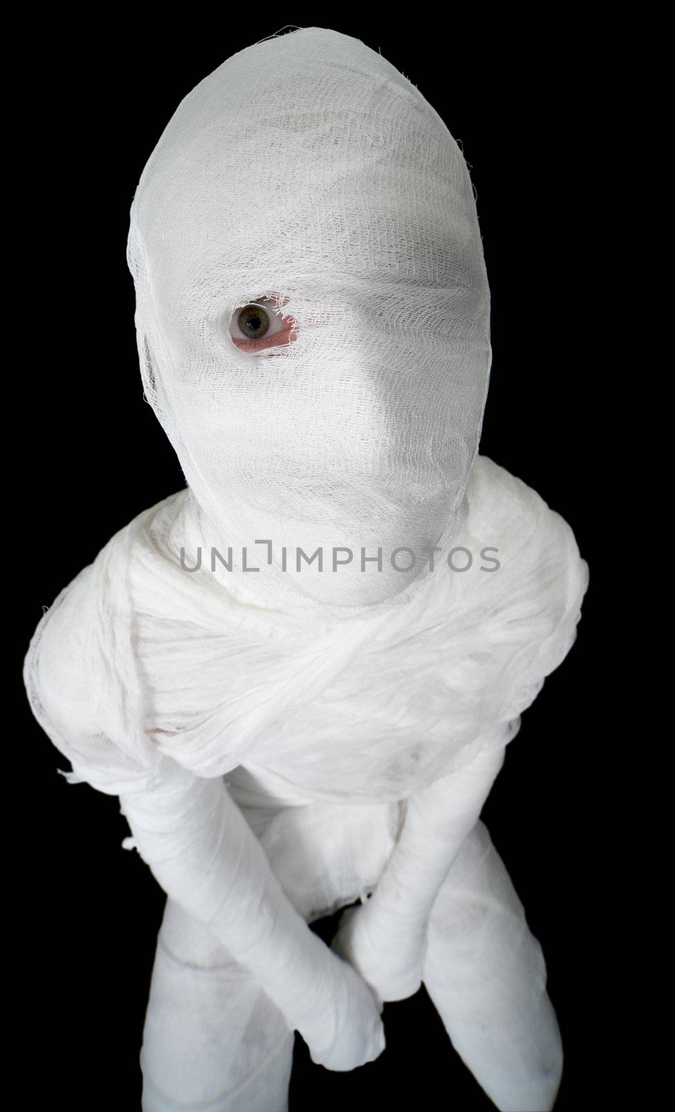 Mummy with open one eye on the black background