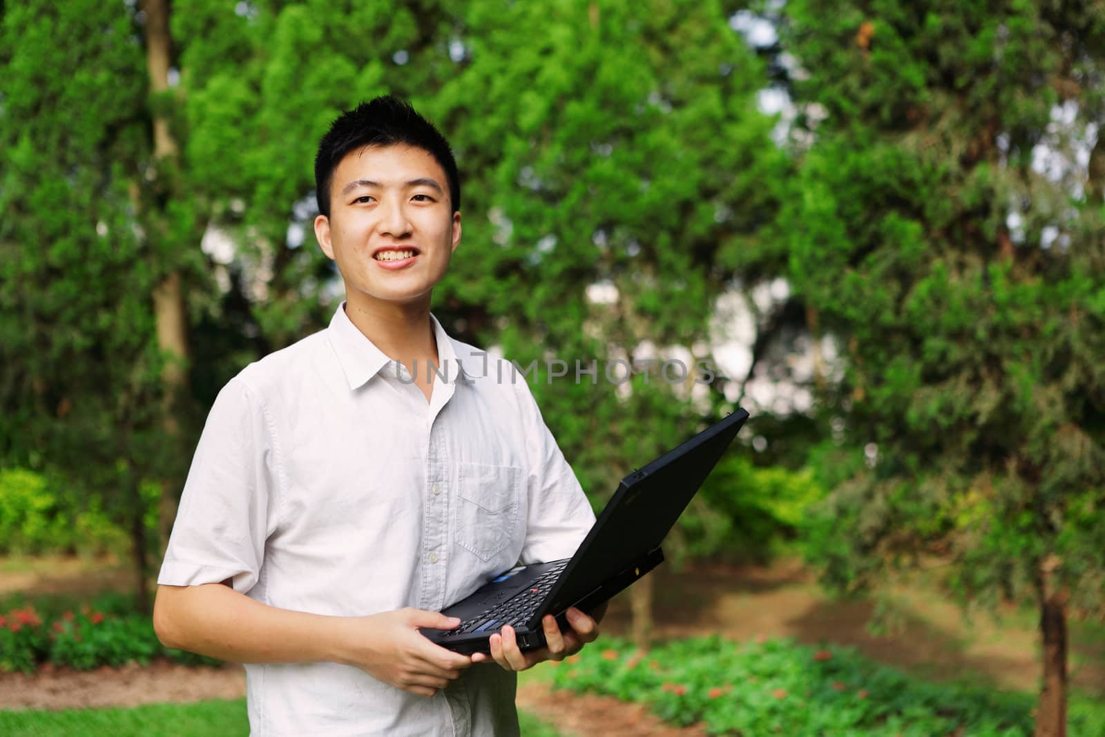 man using computer outdoor by leungchopan