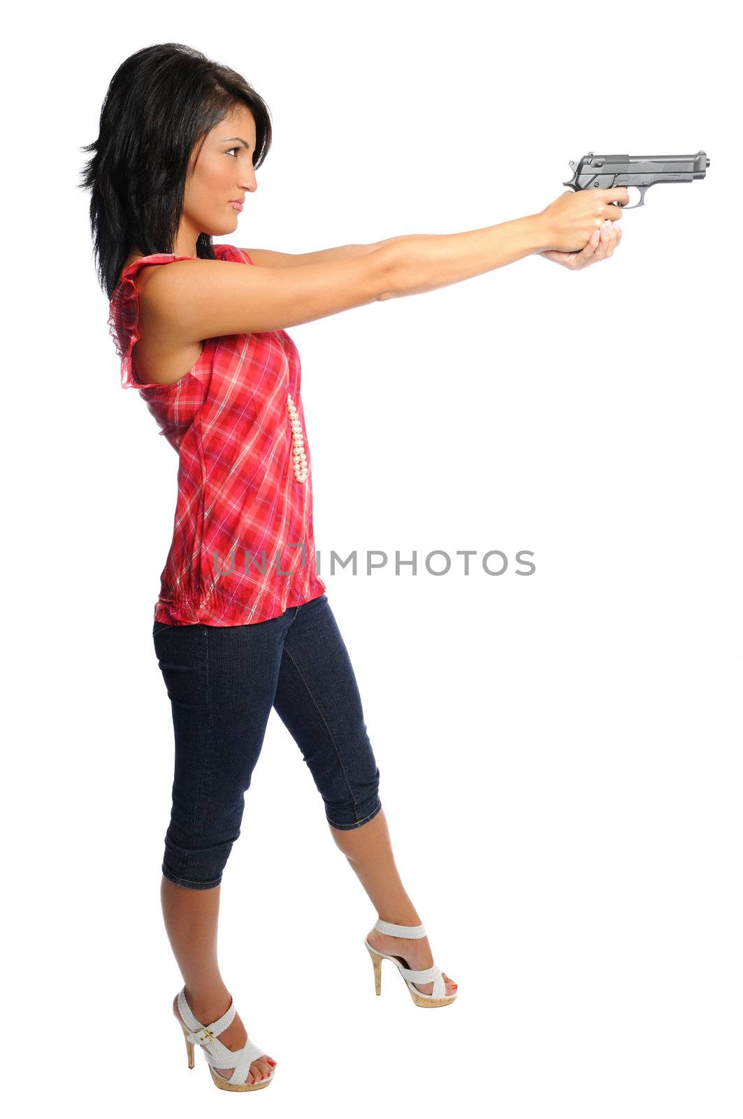 attracive hispanic woman holding a pistol ready to shoot on a white background