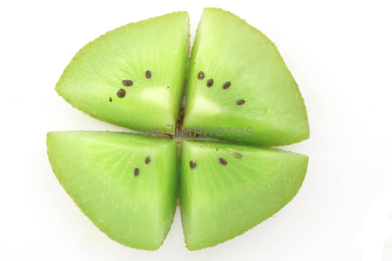 Closeup of Kiwifruit slice isolated in white.
