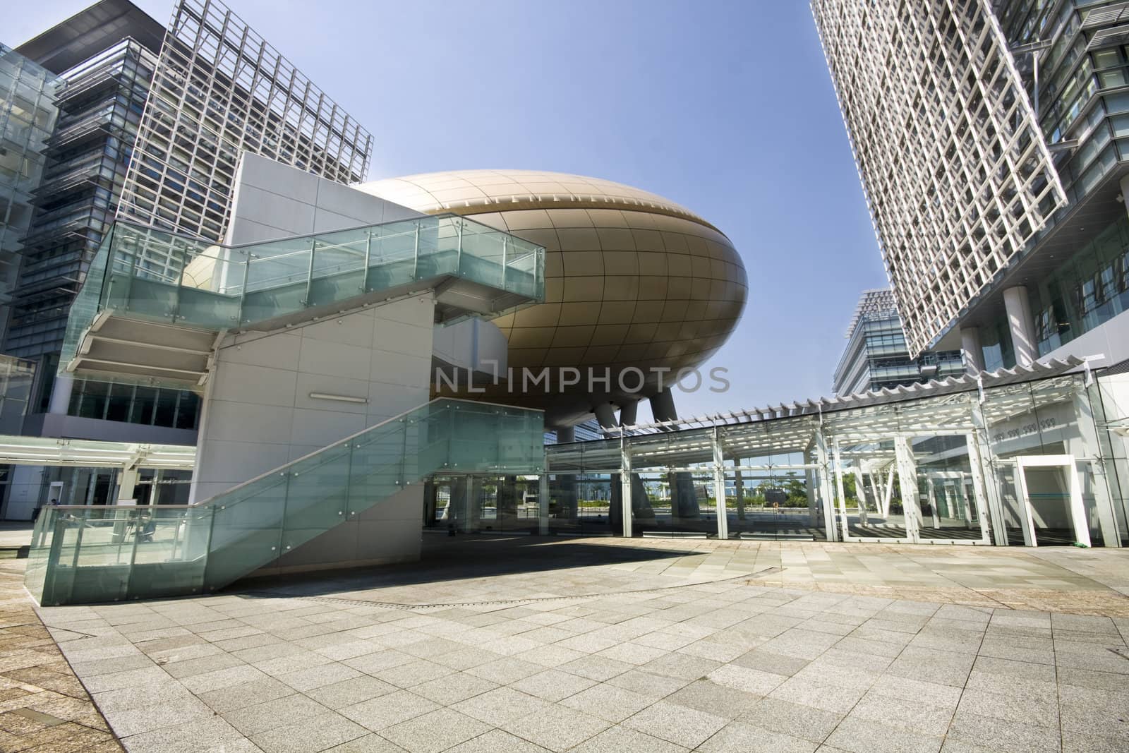 Bright outlook for business. Modern office block with sunny beautiful sky. 
