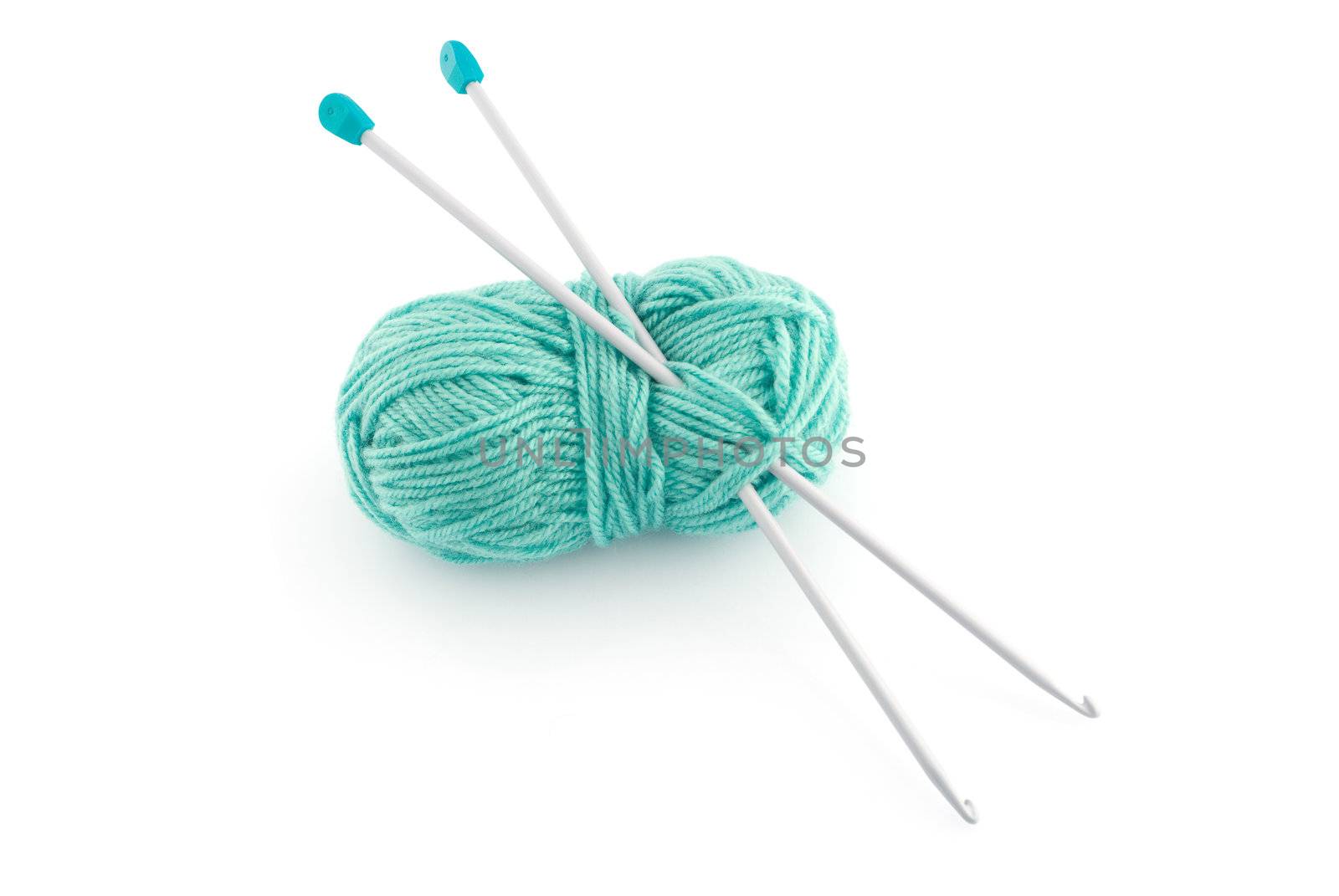 Green ball knitting wool or yarn, with silver knitting needles.