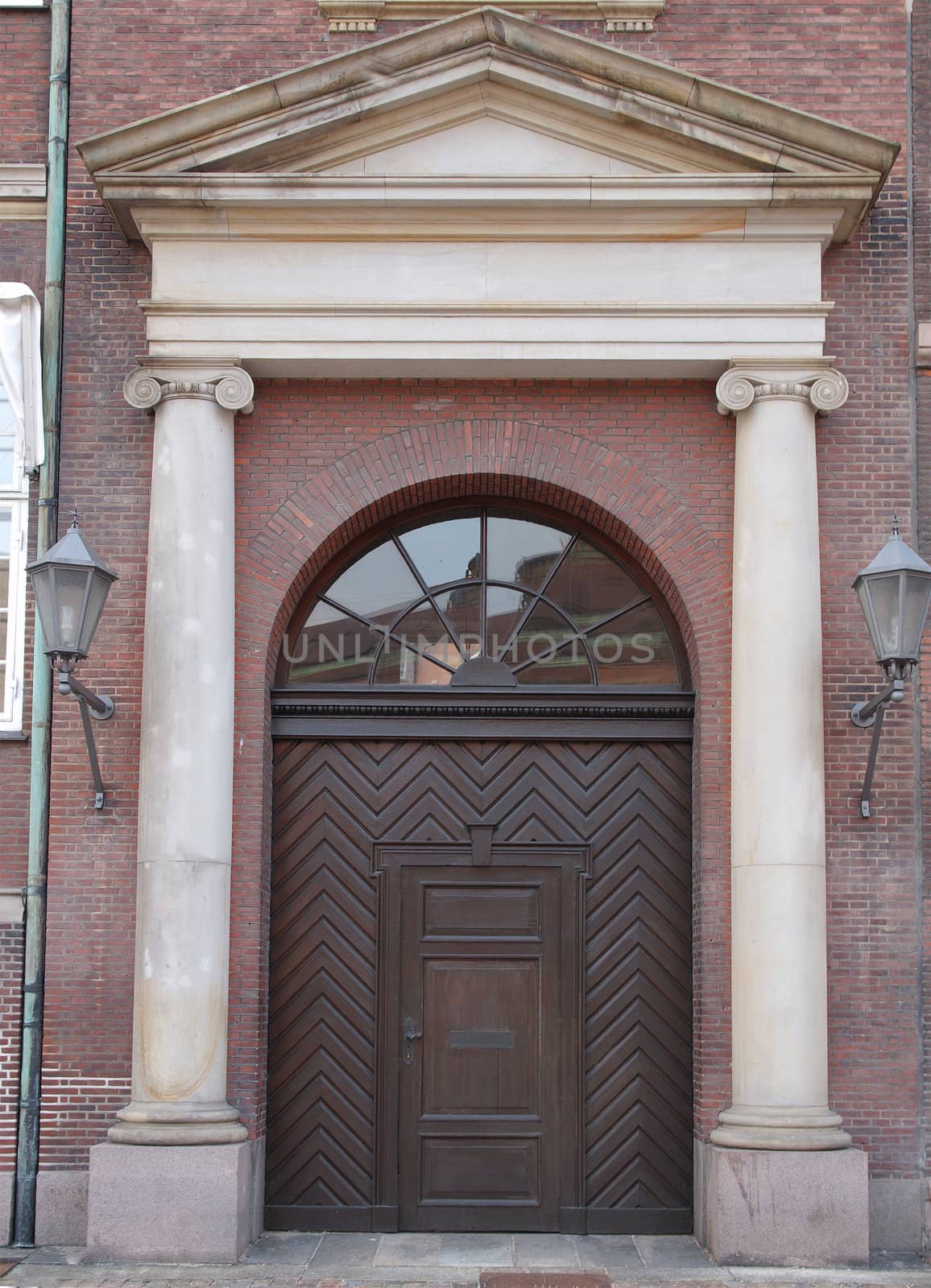 ionic columns and semi-circular arched door        