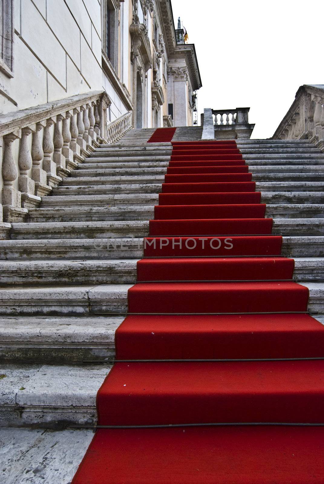 dirty red carpet leading up a staircase