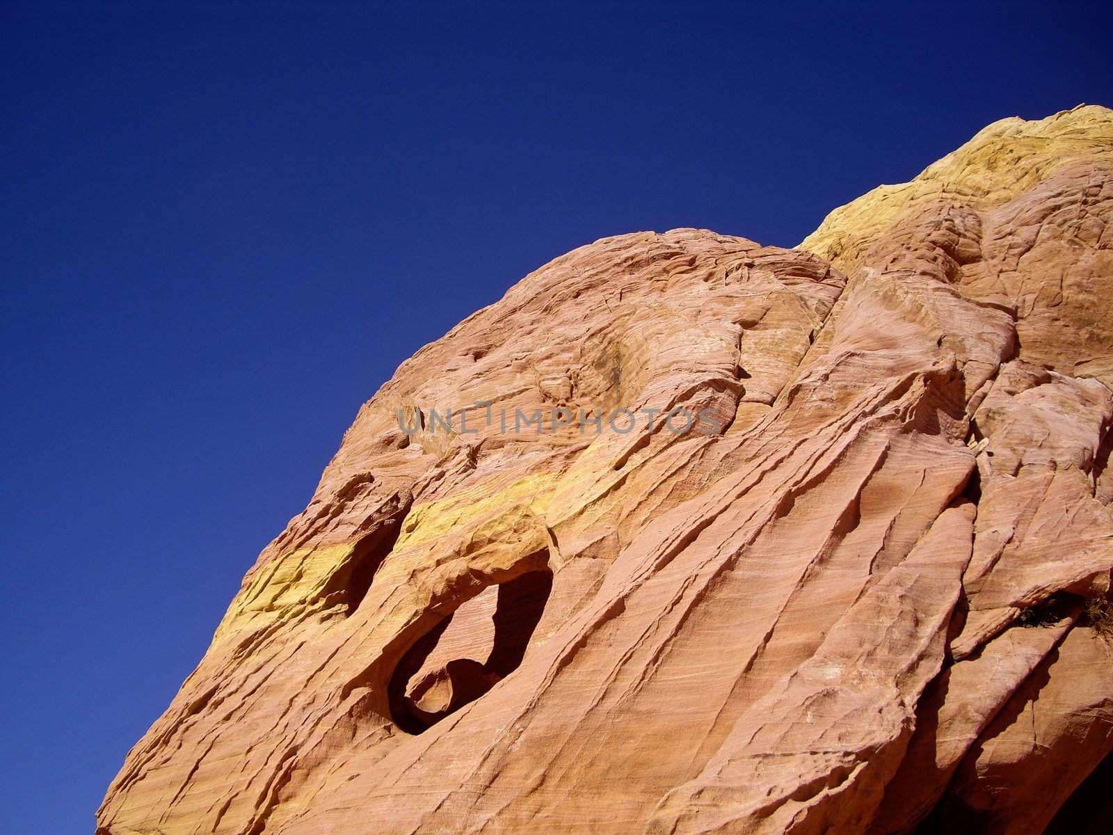 Colorful sandstone rock against blue sky