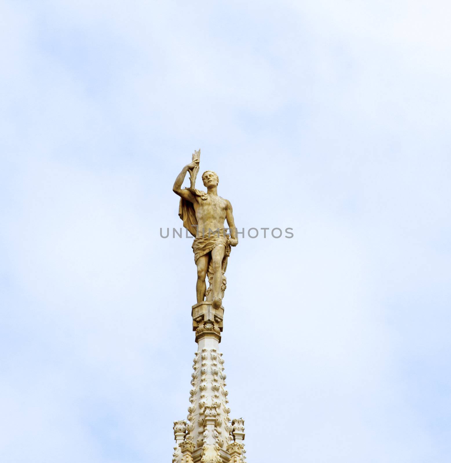 Statue on top of a "guglia" of Duomo of Milano, one of the most important monuments of christianity