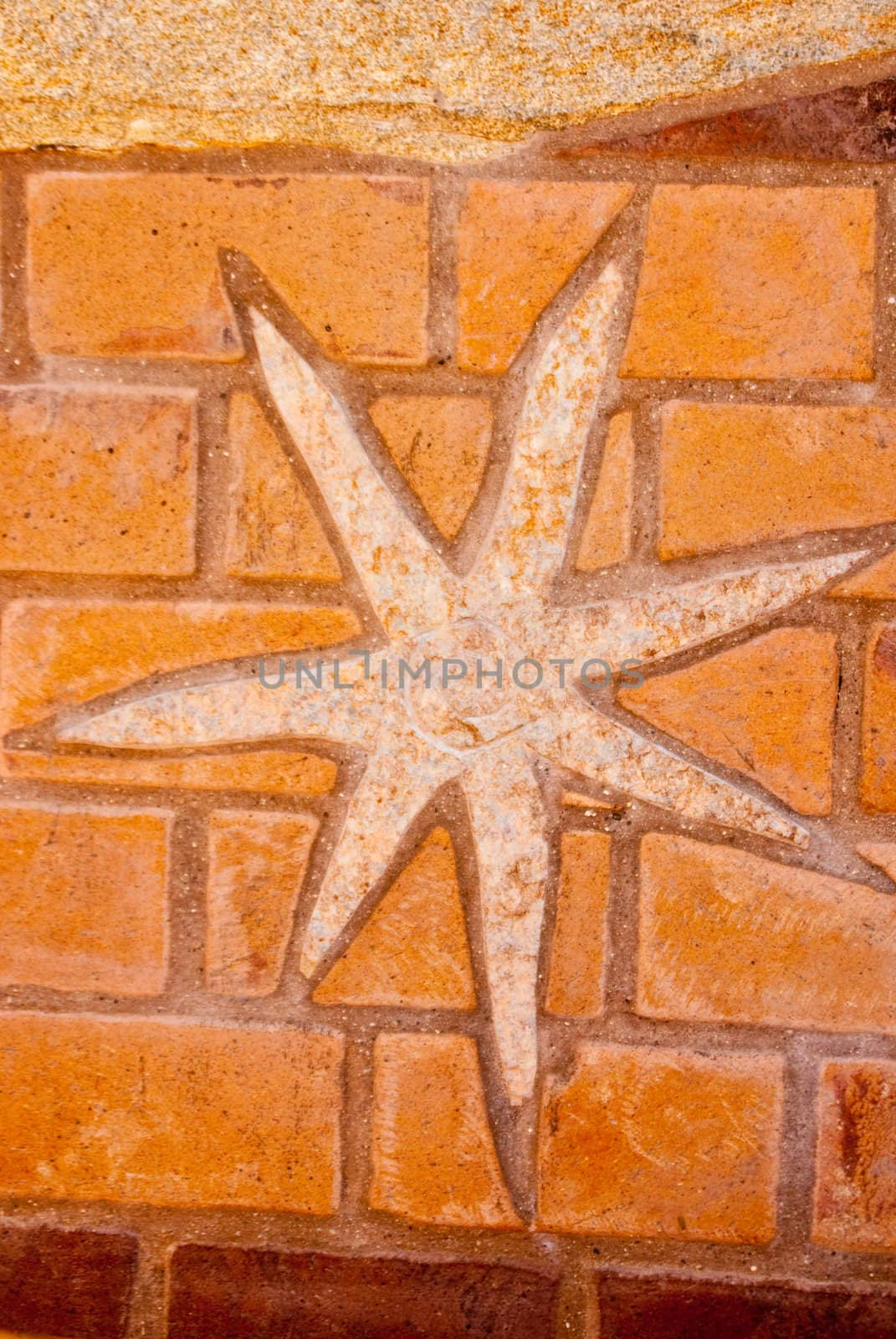 Star mosaic of textures stone on brick.