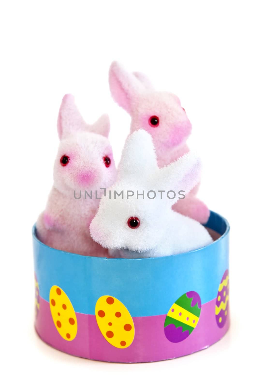 Cute Easter bunny toys in basket isolated on white background