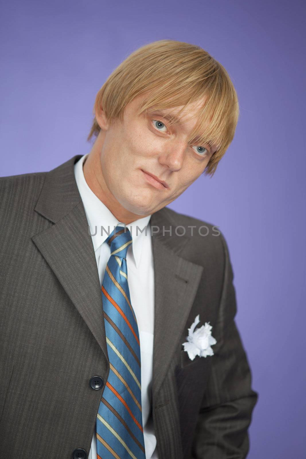 Portrait of the young man - the groom on violet background