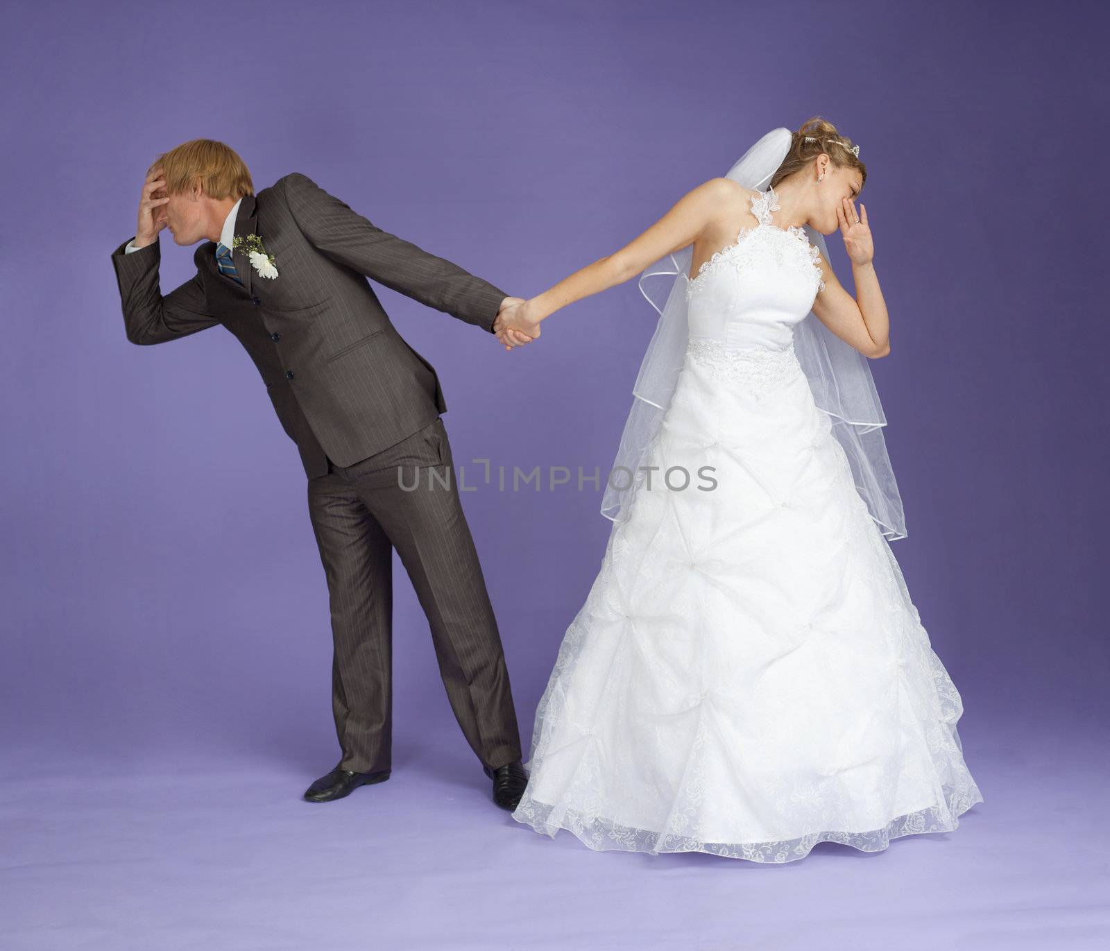 Comical emotional groom and the bride holding hands on violet background