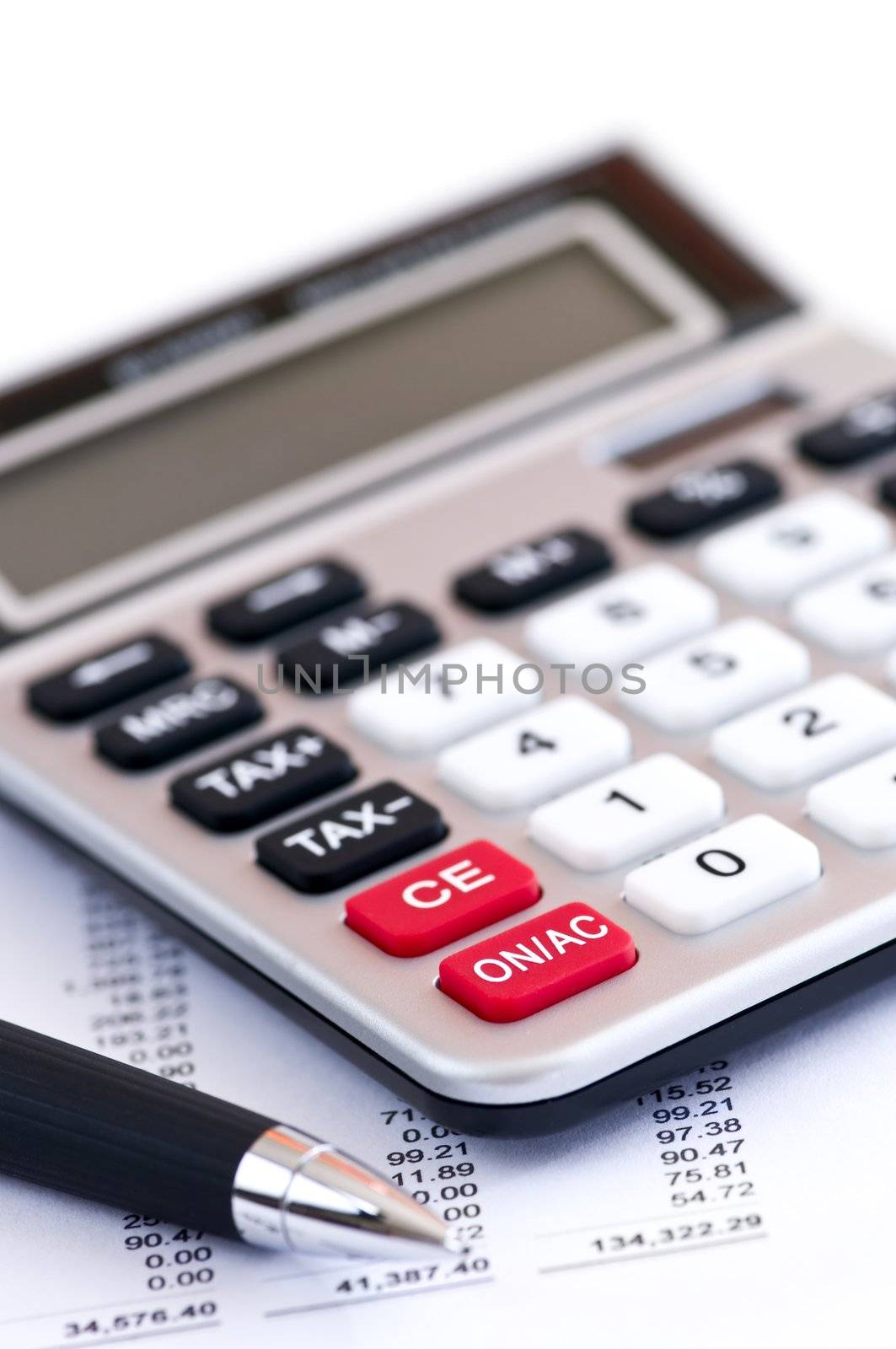 Calculating numbers for income tax return with pen and calculator