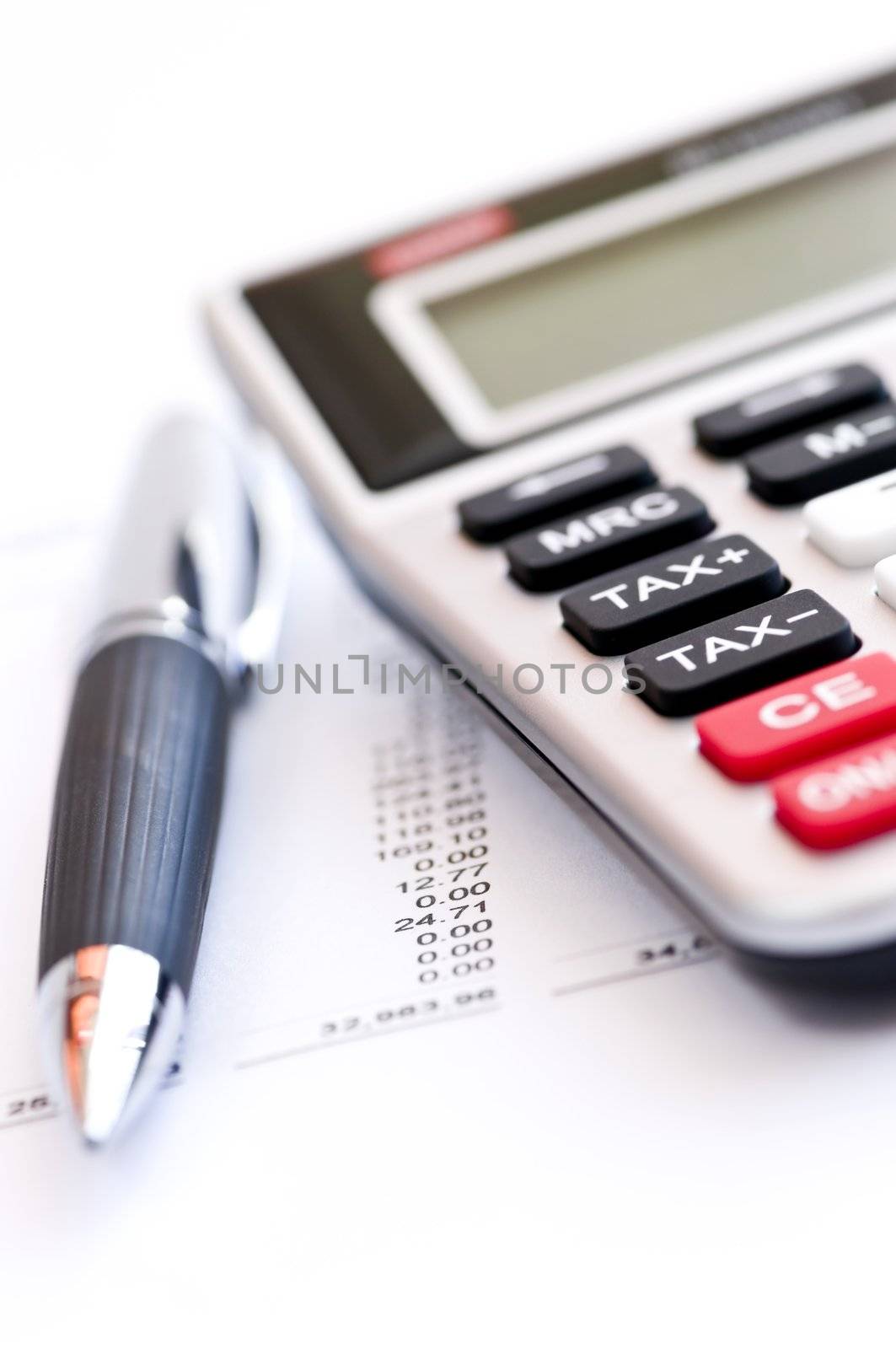Calculating numbers for income tax return with pen and calculator