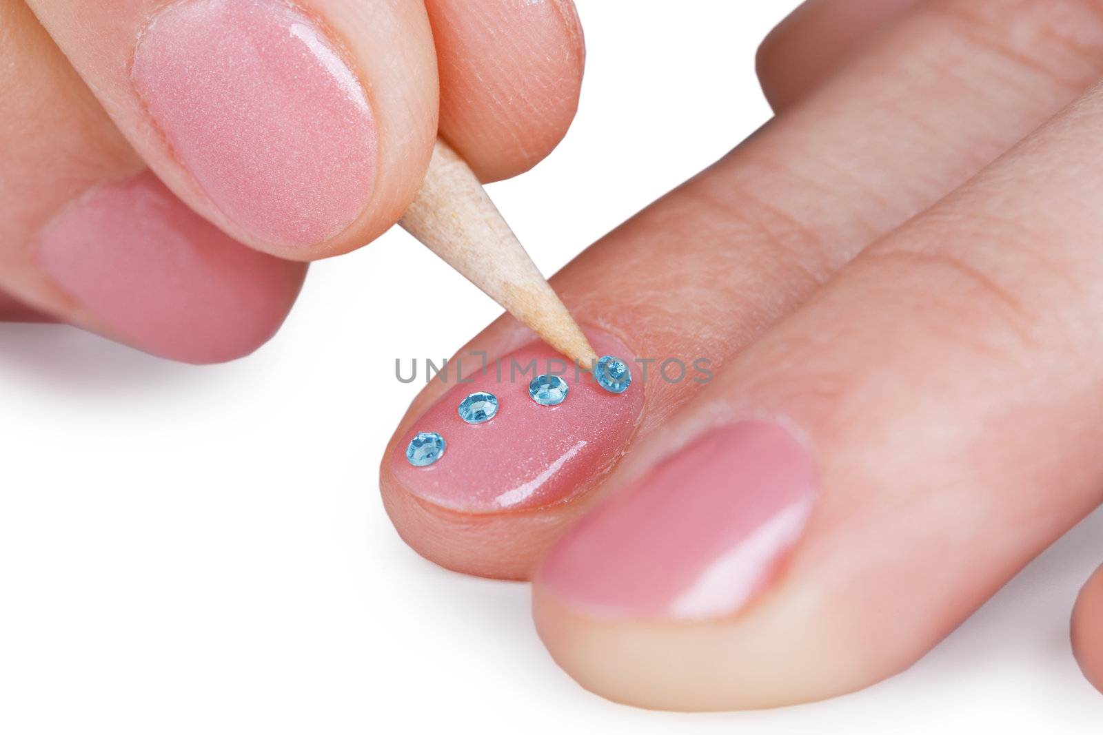 Close up - gluing a paste on nails, isolated on white background