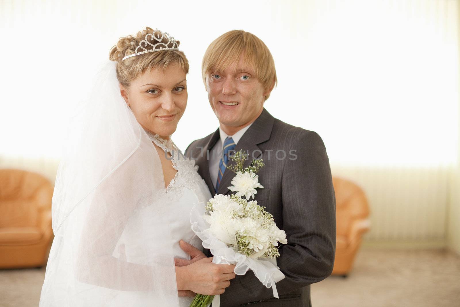 Groom and bride in solemn hall for wedding by pzaxe