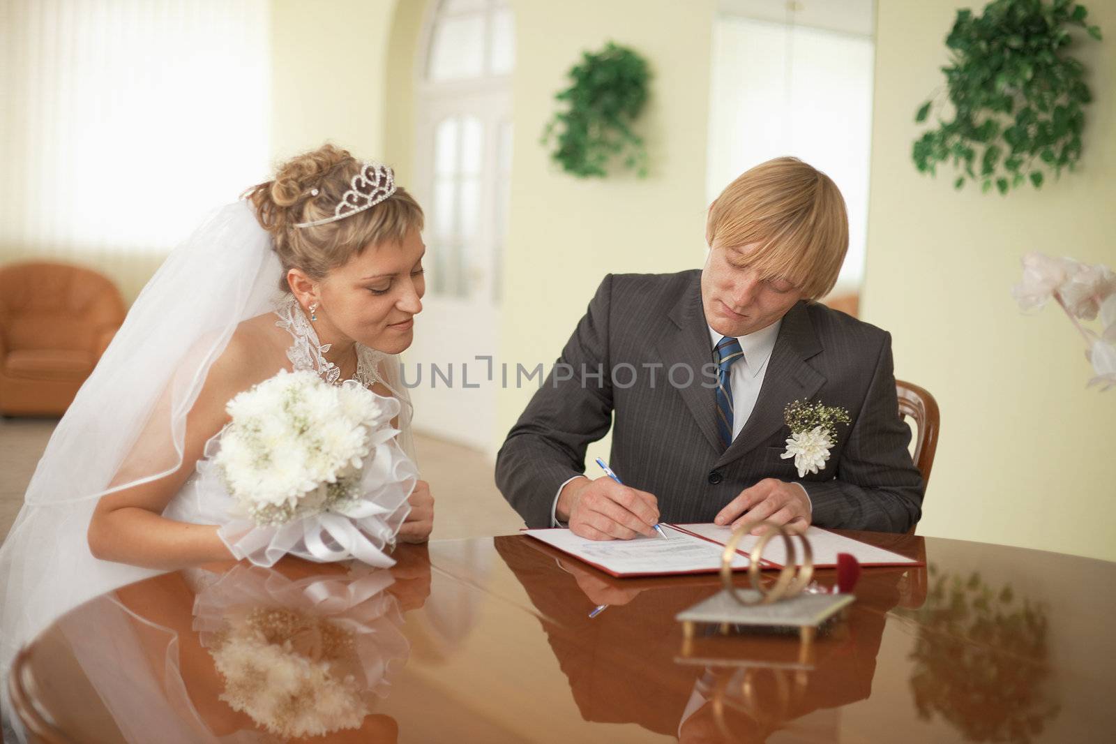 The groom and the bride at the moment of solemn registration of marriage