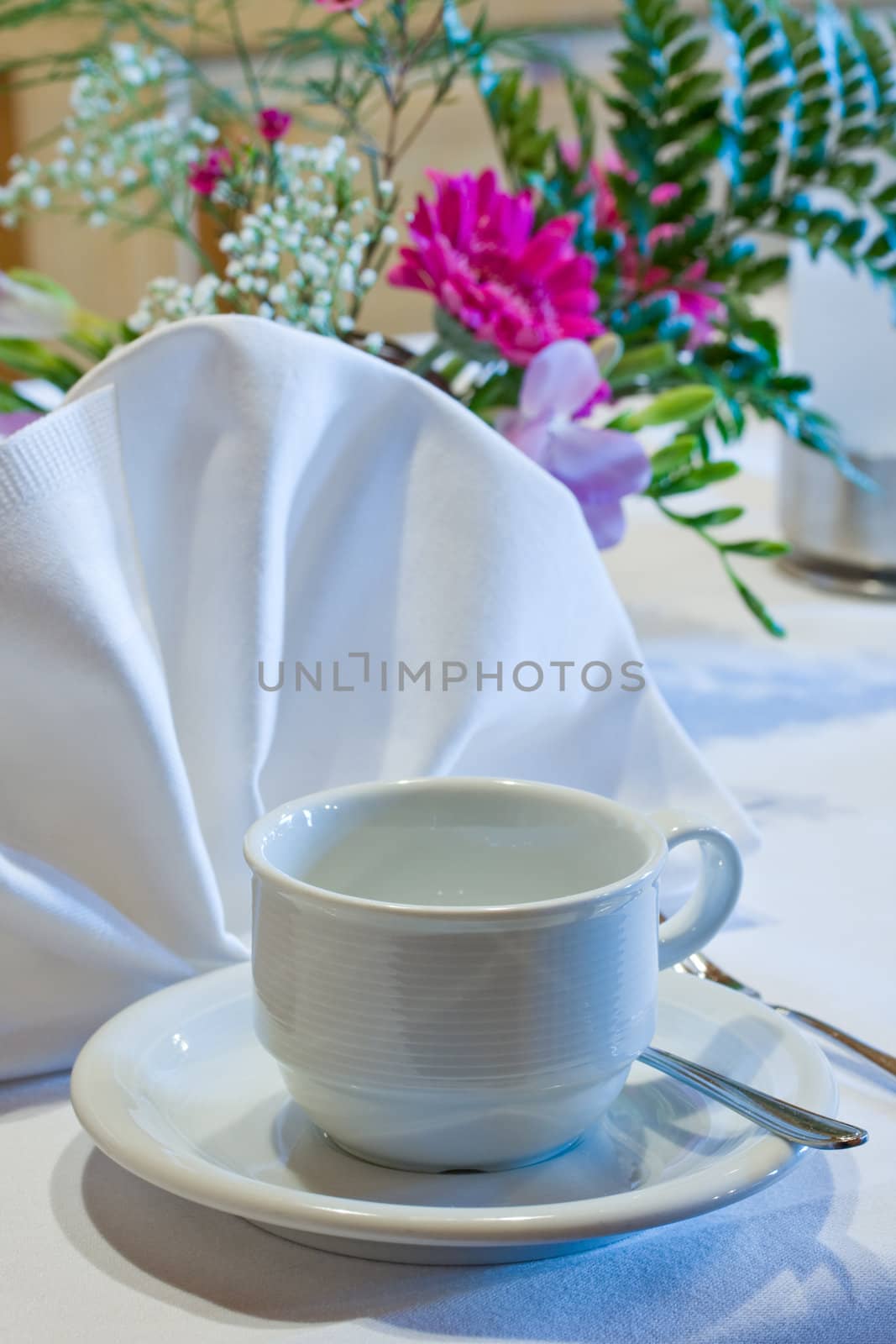 empty coffee cup on a decorated table by bernjuer