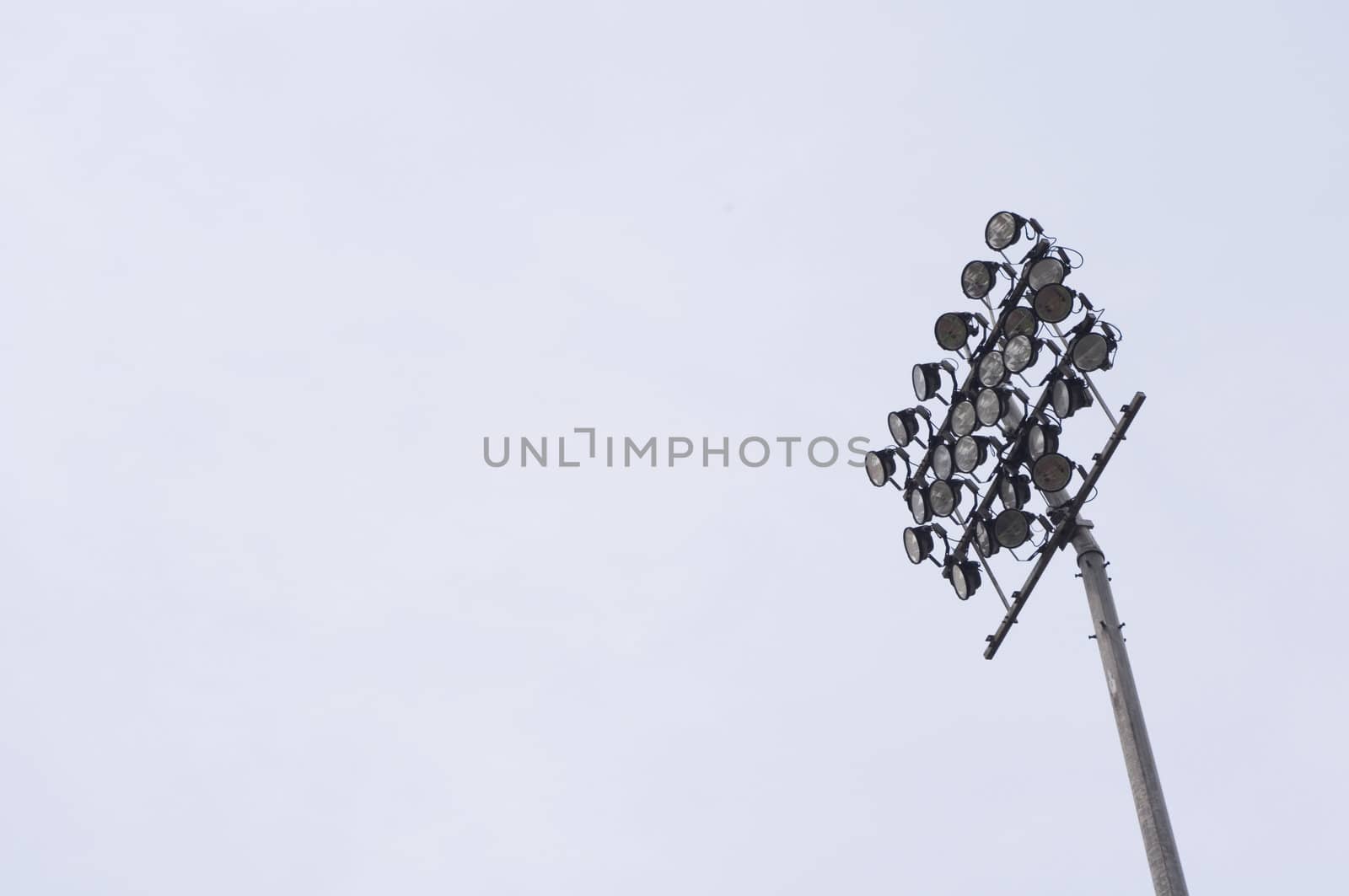 a stadium light, isolated on plain sky, with space for text or message.