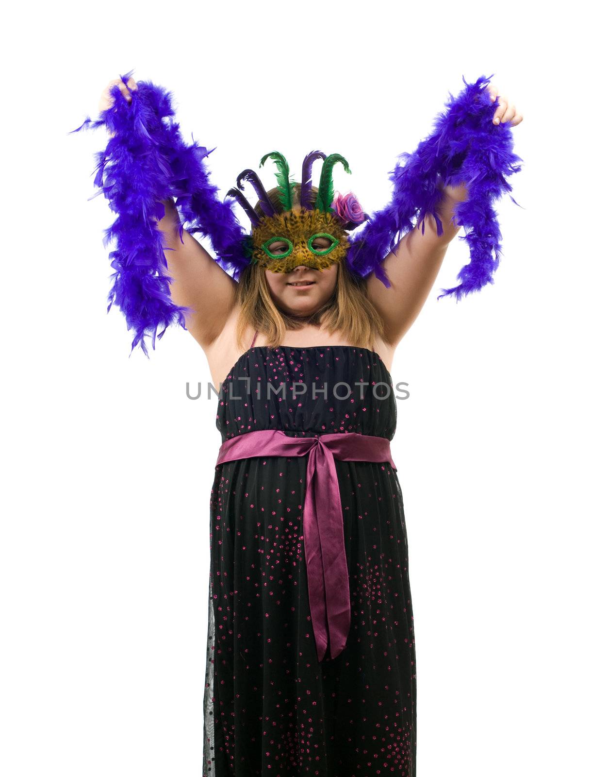 A young girl dressed for a costume party is wearing a mask and a nice dress, isolated against a white background