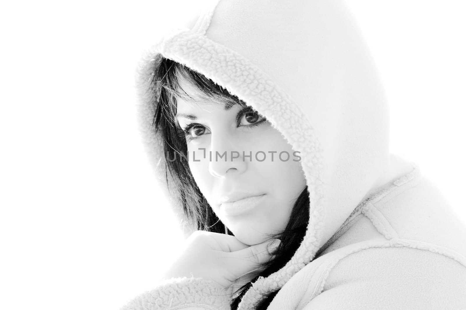 A young hispanic woman with a hood on her head in black and white.