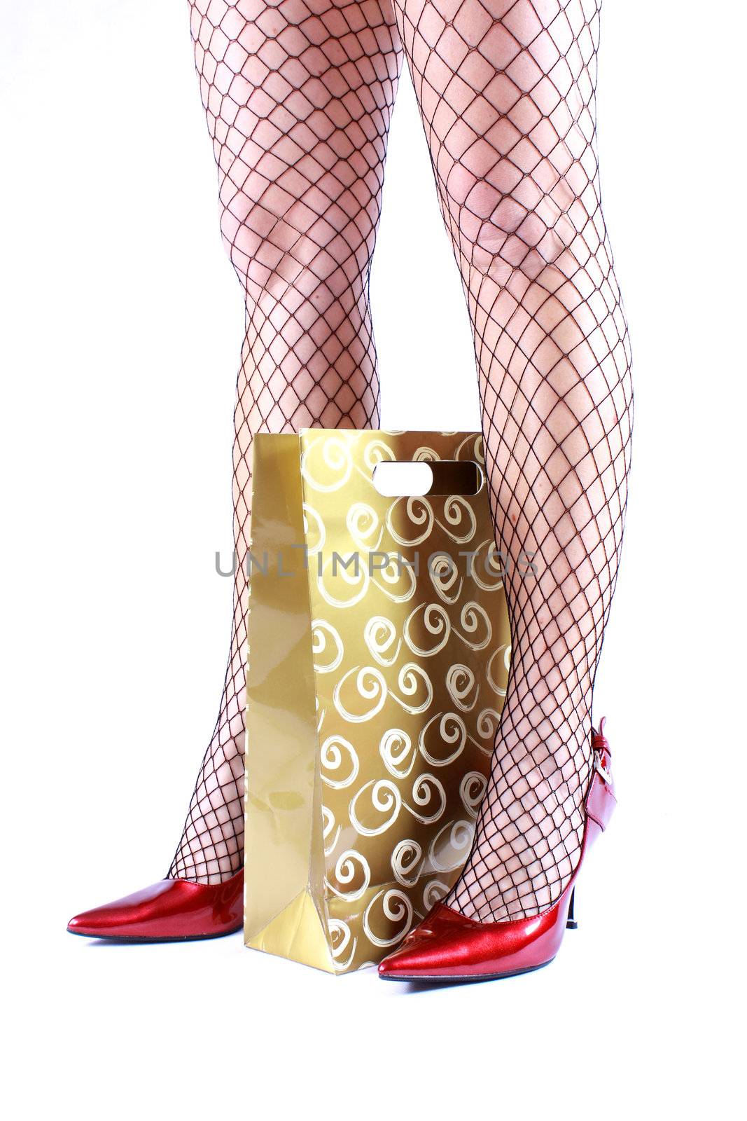 Beautiful legs in stockings and shopping bag on white background